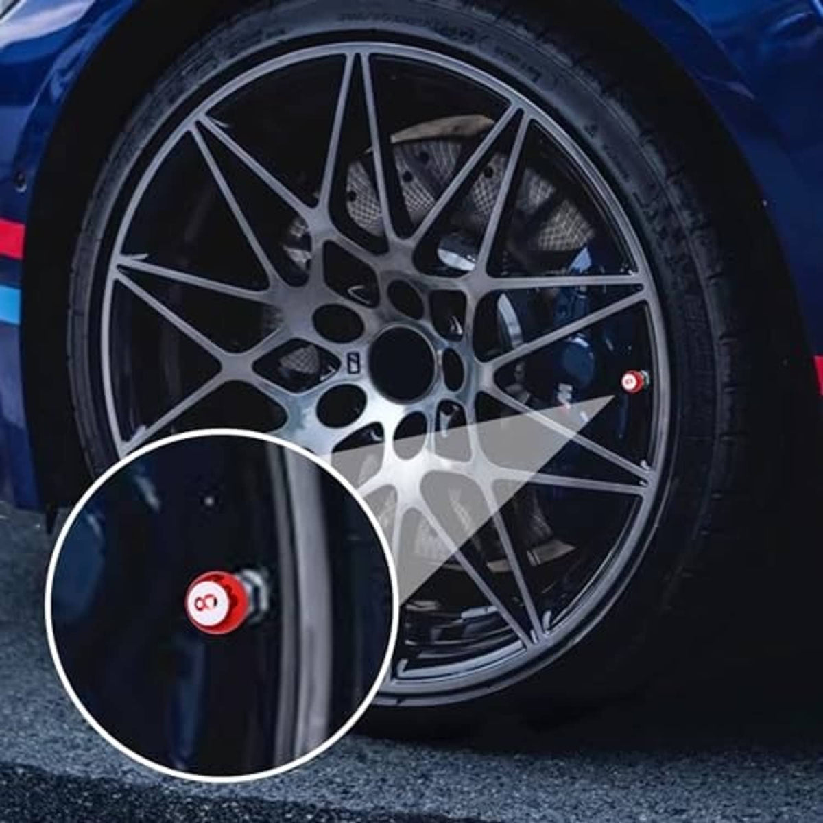 Wheel close-up featuring a small red “8” tire valve stem cap.
