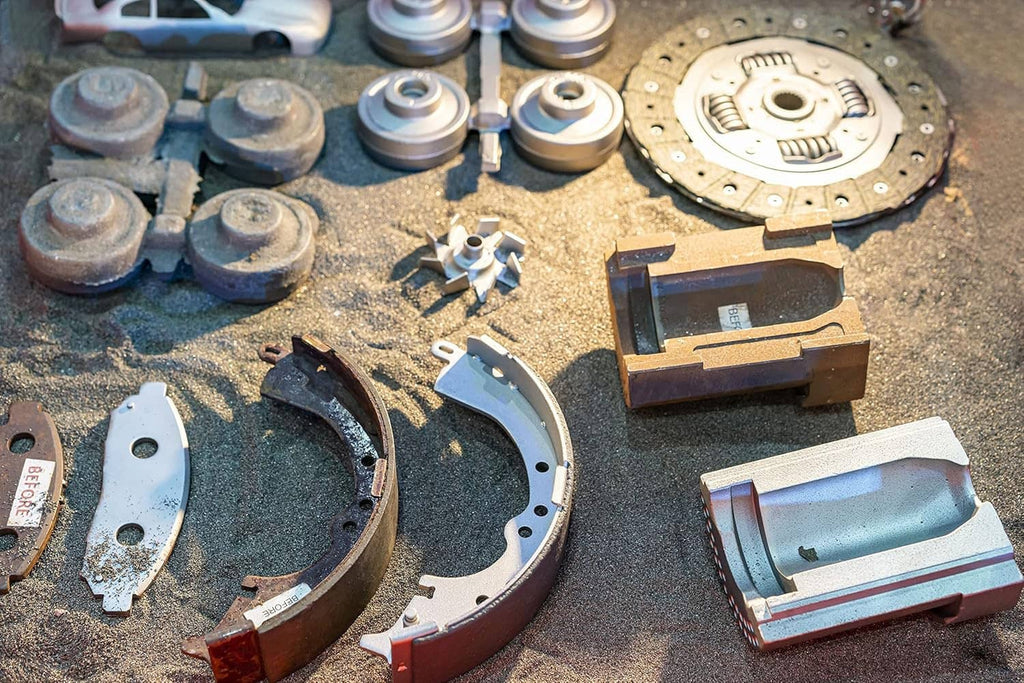 Automotive brake and clutch parts with abrasive residue on a workbench