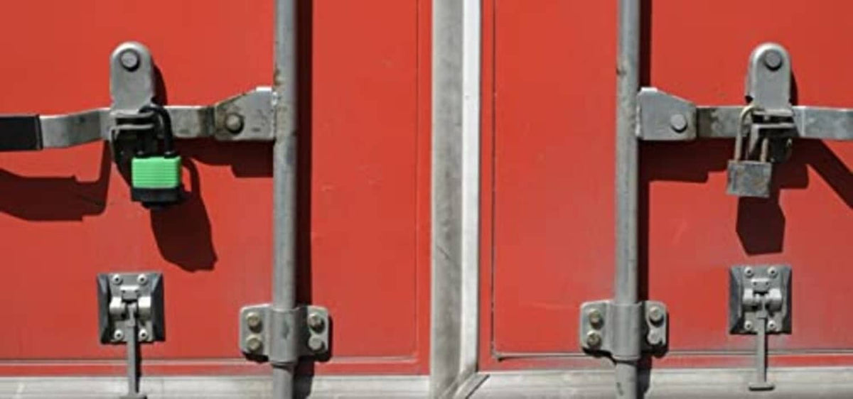 Small padlocks on metal gate hardware with multiple keyed lock fixtures
