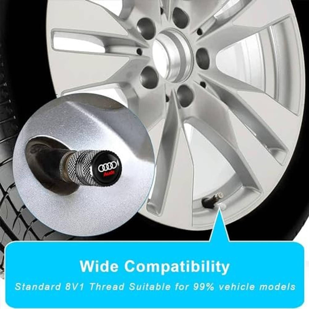 Black knurled tire valve stem cap with Audi logo on a wheel valve opening