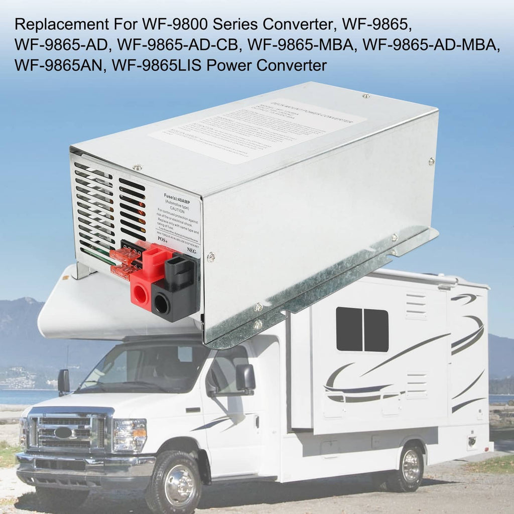 Metal RV power converter charger mounted near a white RV on an outdoor road