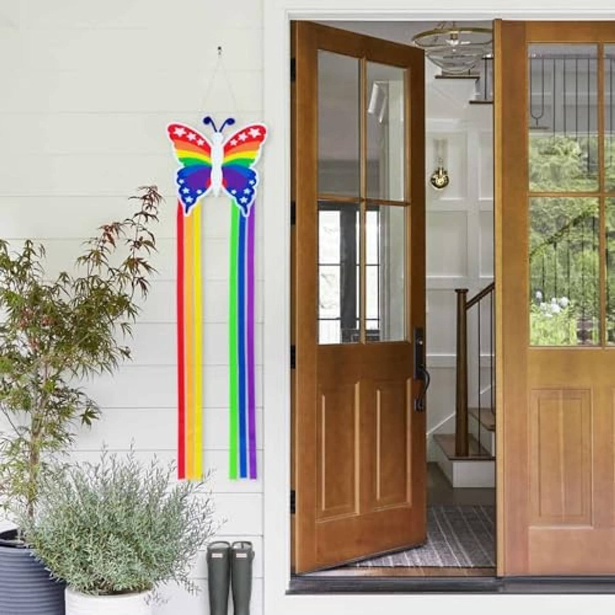 Hanging butterfly windsock with rainbow ribbon tails and blue star-spangled wings
