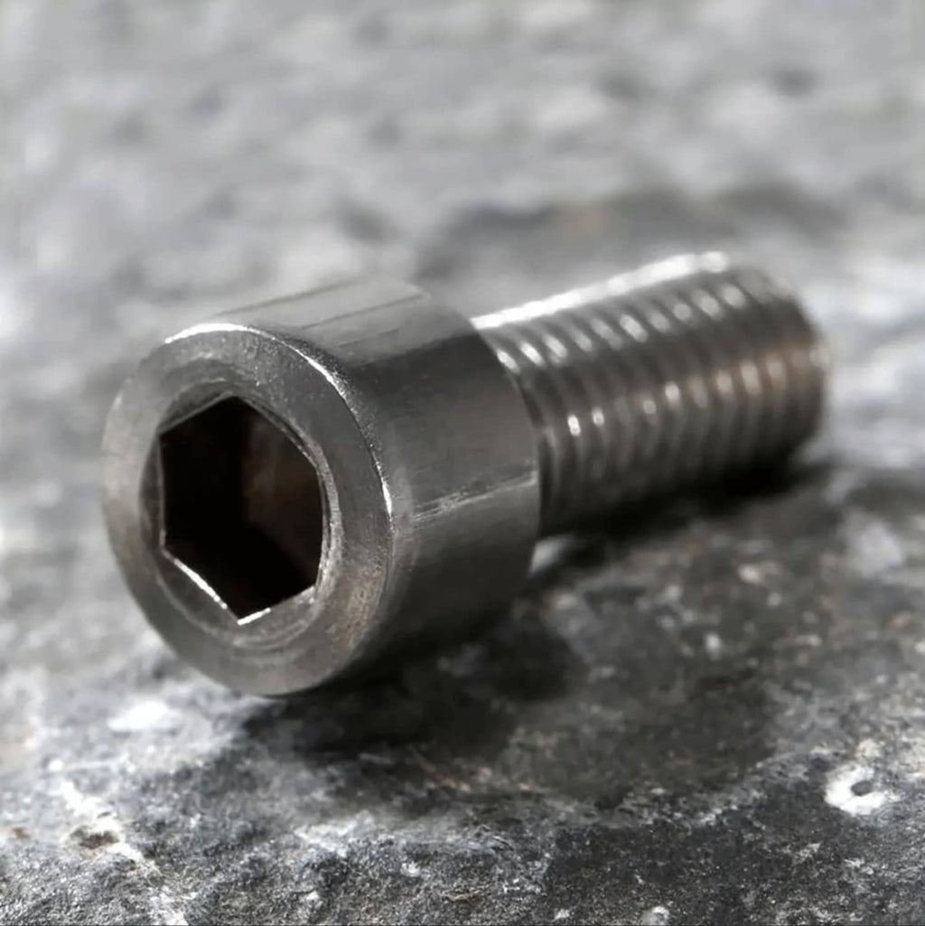 Close-up of silver hex socket cap bolt head and threaded shaft