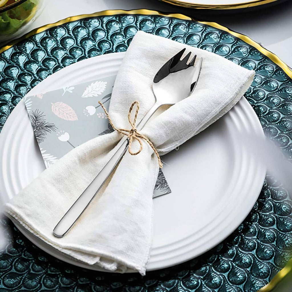 Stainless steel sporks on folded white napkin, spoon bowls and fork tines