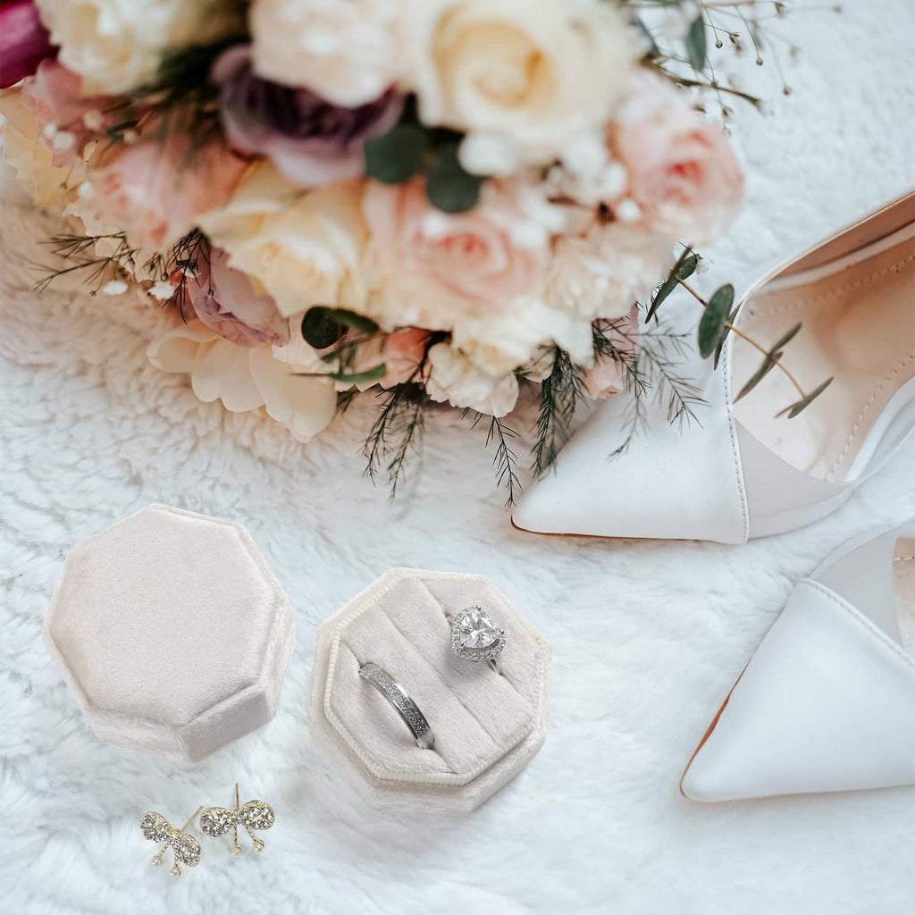 Beige octagon velvet ring box set, one open with ring on cushion