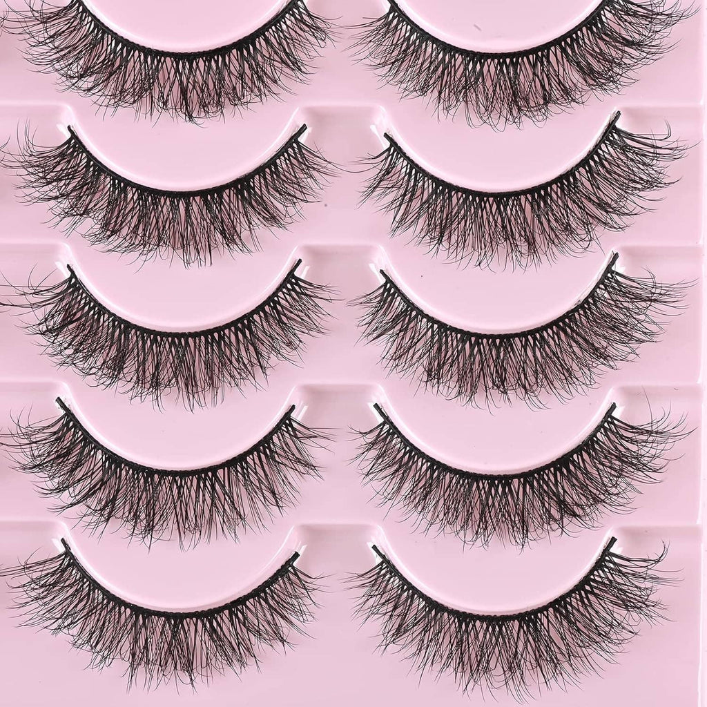 Close-up of natural short wispy false mink lashes on pink tray, multiple pairs