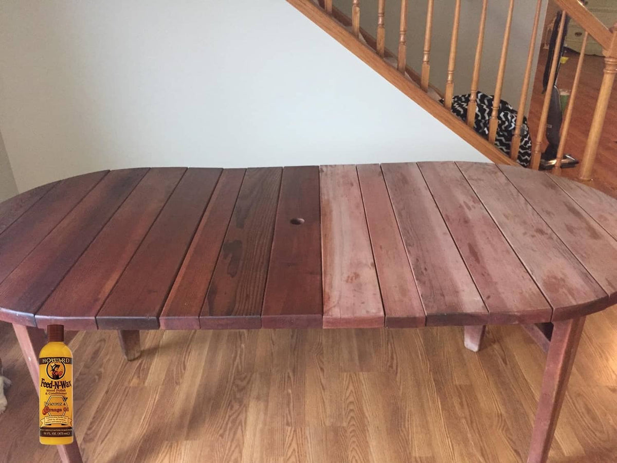 Howard Feed-N-Wax wood polish bottle on wooden bench planks