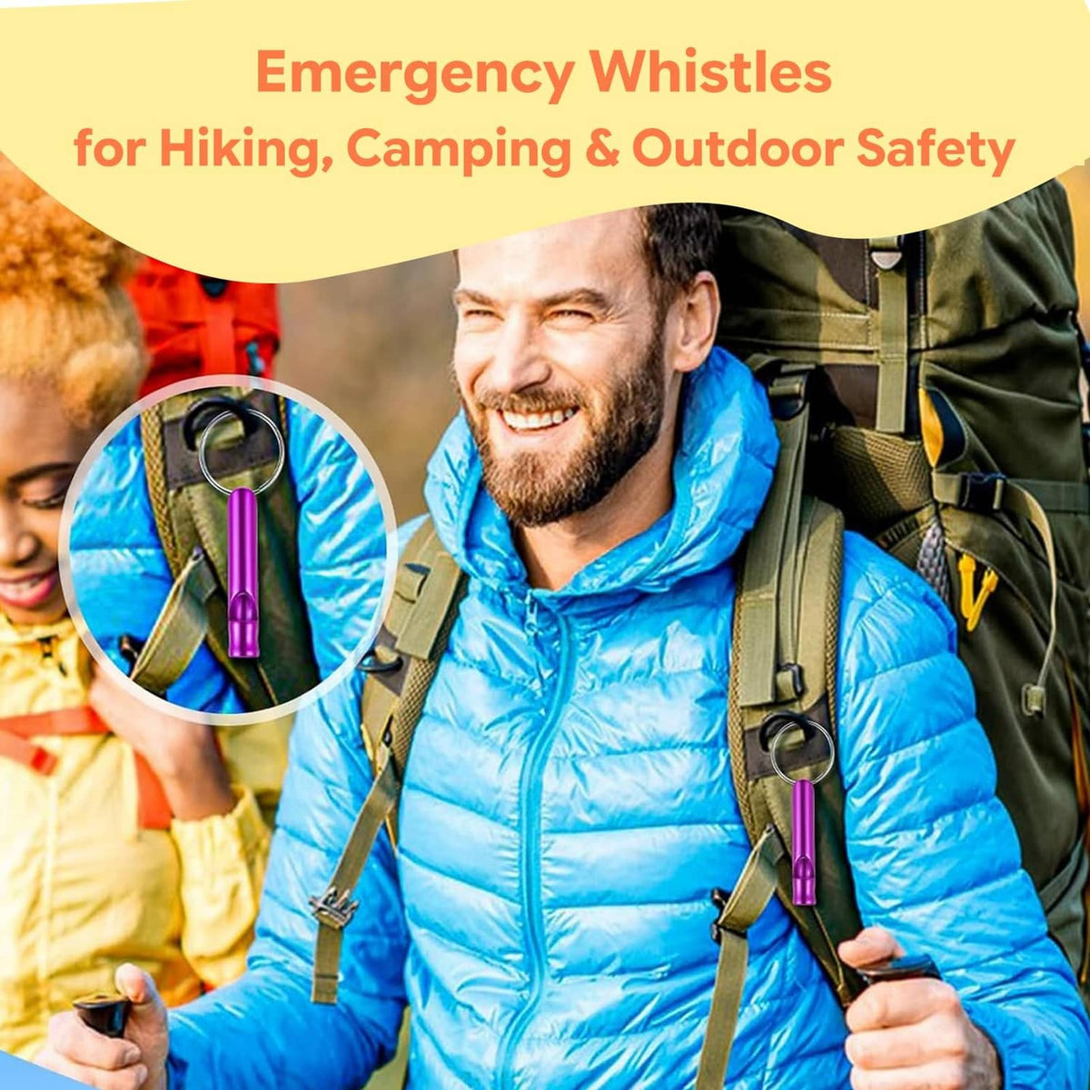 Red aluminum emergency whistle keychain on an outdoor backpack strap with metal ring