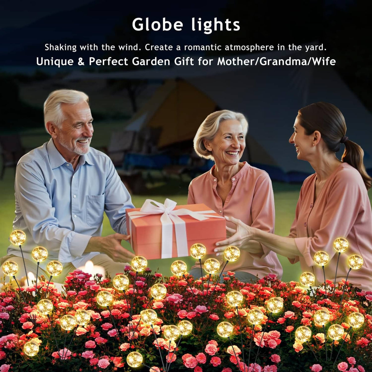 Warm white solar globe lights glowing above flower bed with a gift box centerpiece
