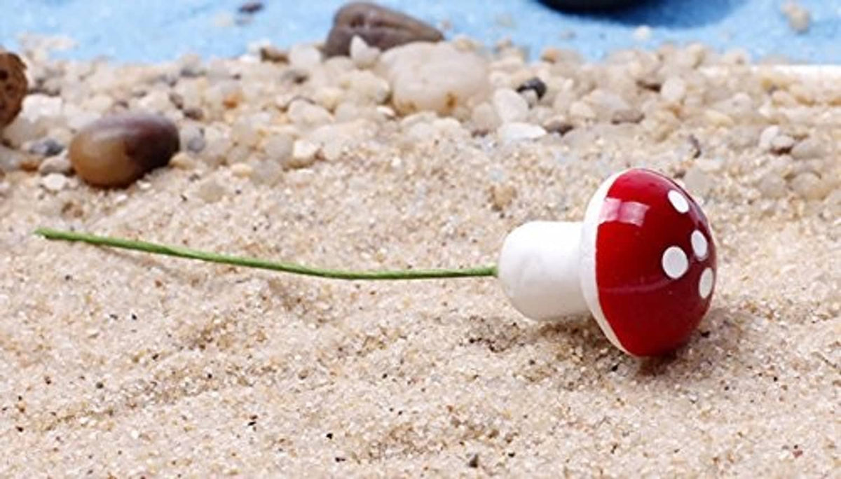 Red-and-white spotted foam mushroom on a green stem for garden pot decor