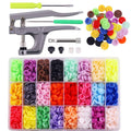 Snap button pliers with assorted colored plastic snap buttons and replacement parts