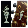 Inlay decal sticker showing teal cup and candlestick icons on dark backing