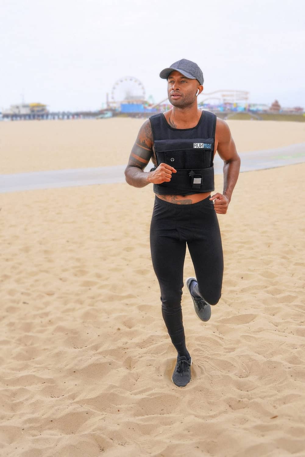 Black weighted vest worn while running, front view with adjustable straps