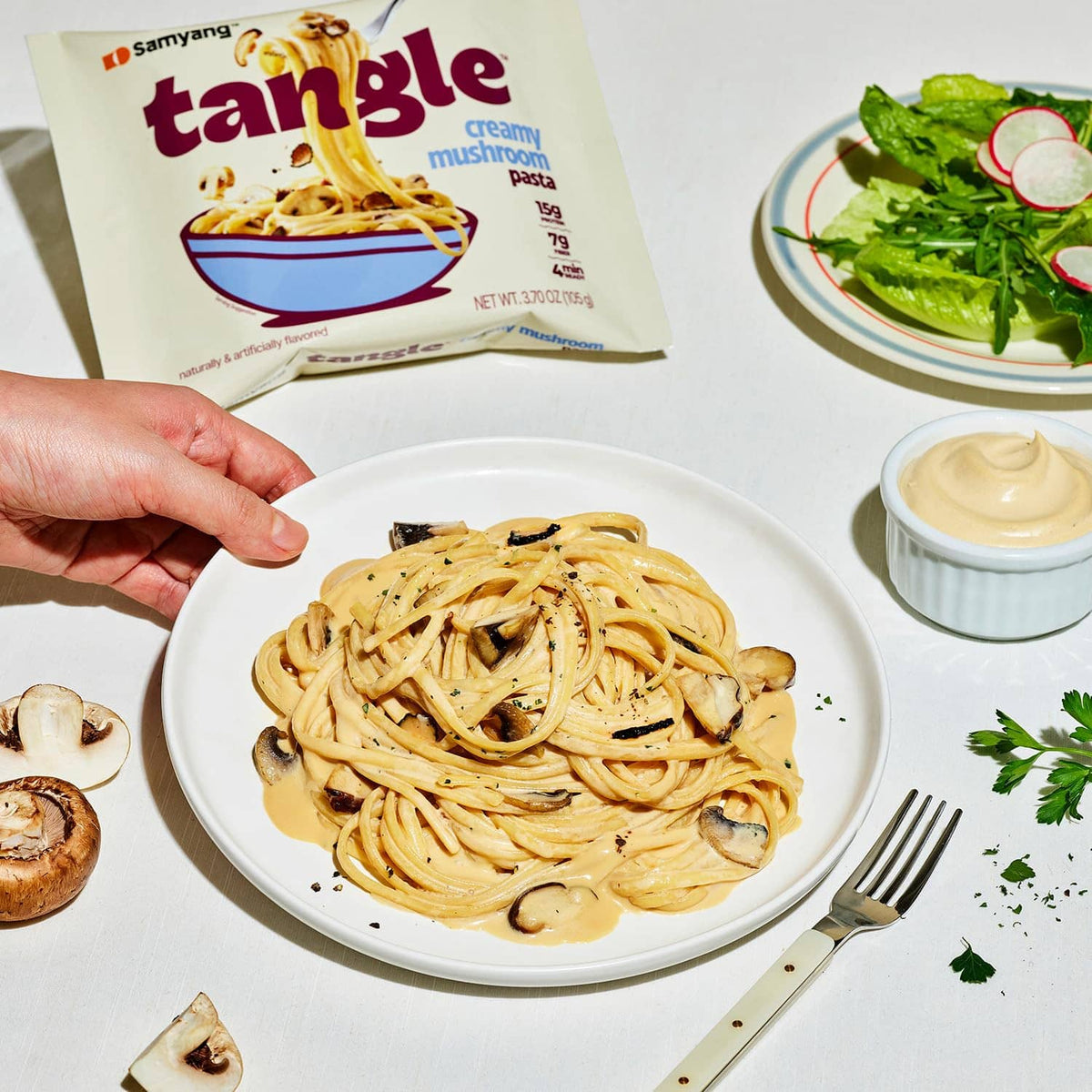 Creamy mushroom linguine pasta in a white bowl with sliced mushrooms and sauce