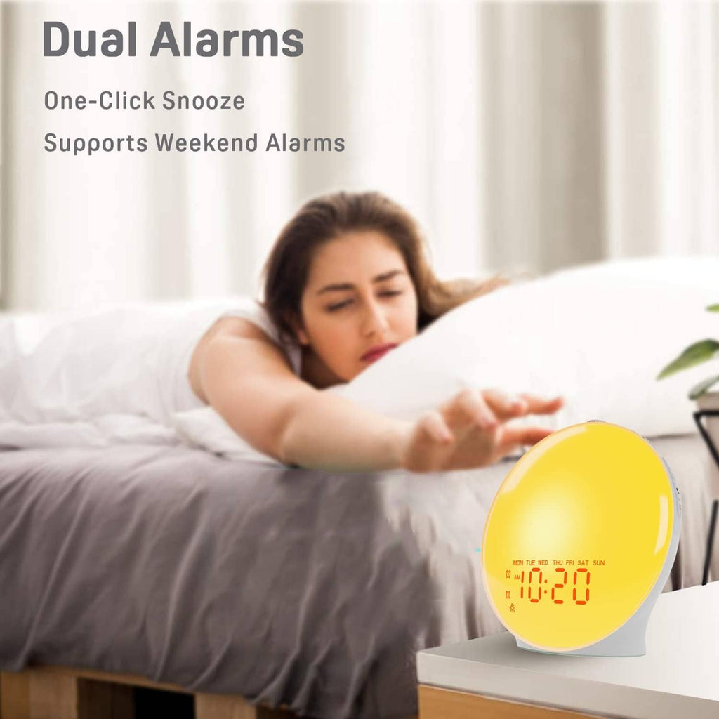 Sunrise alarm clock with glowing yellow display on a bedside nightstand