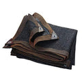 Black shade cloth with striped bound edge and metal grommets, folded