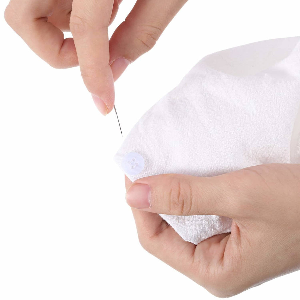 Hand sewing with needle and thread on fabric using a small white button