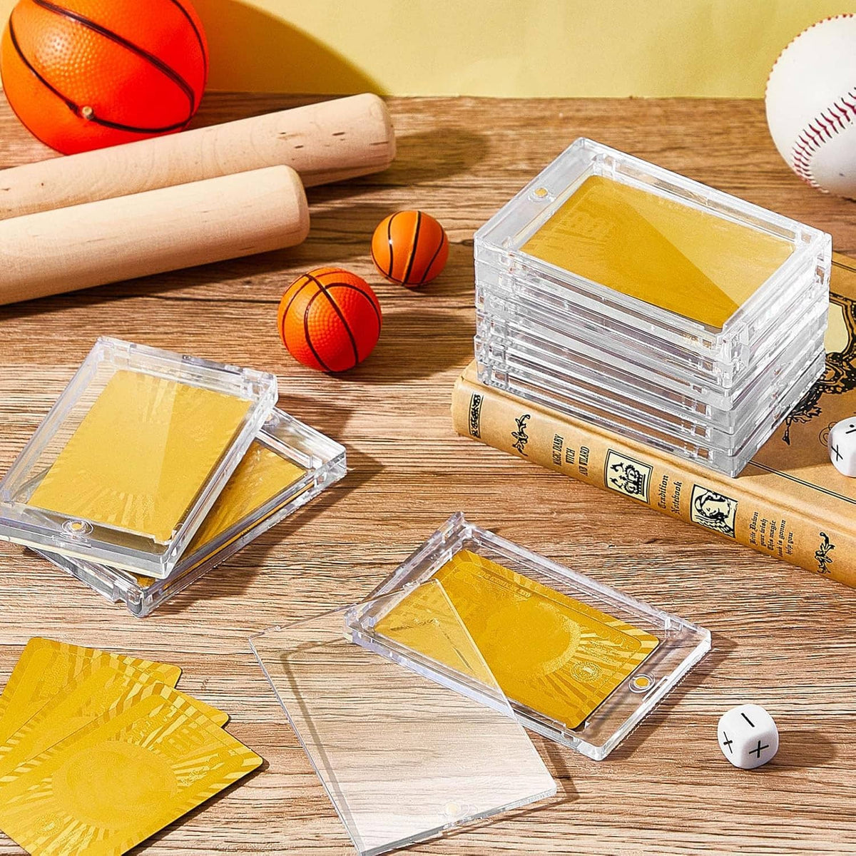 Clear magnetic acrylic card holders with yellow card inserts on a wooden surface
