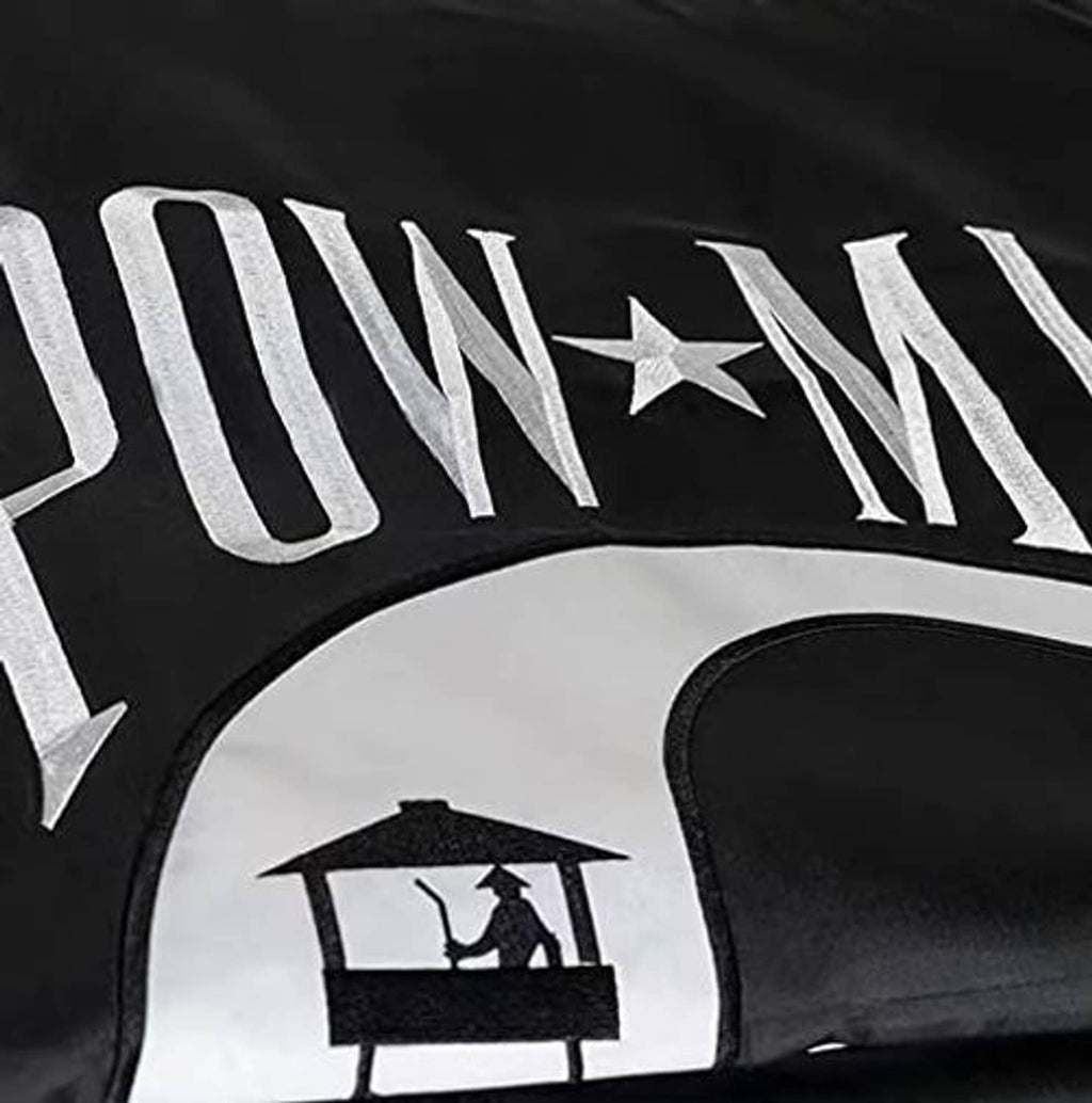 Black flag close-up with 'POW*MIA' stitched letters and star