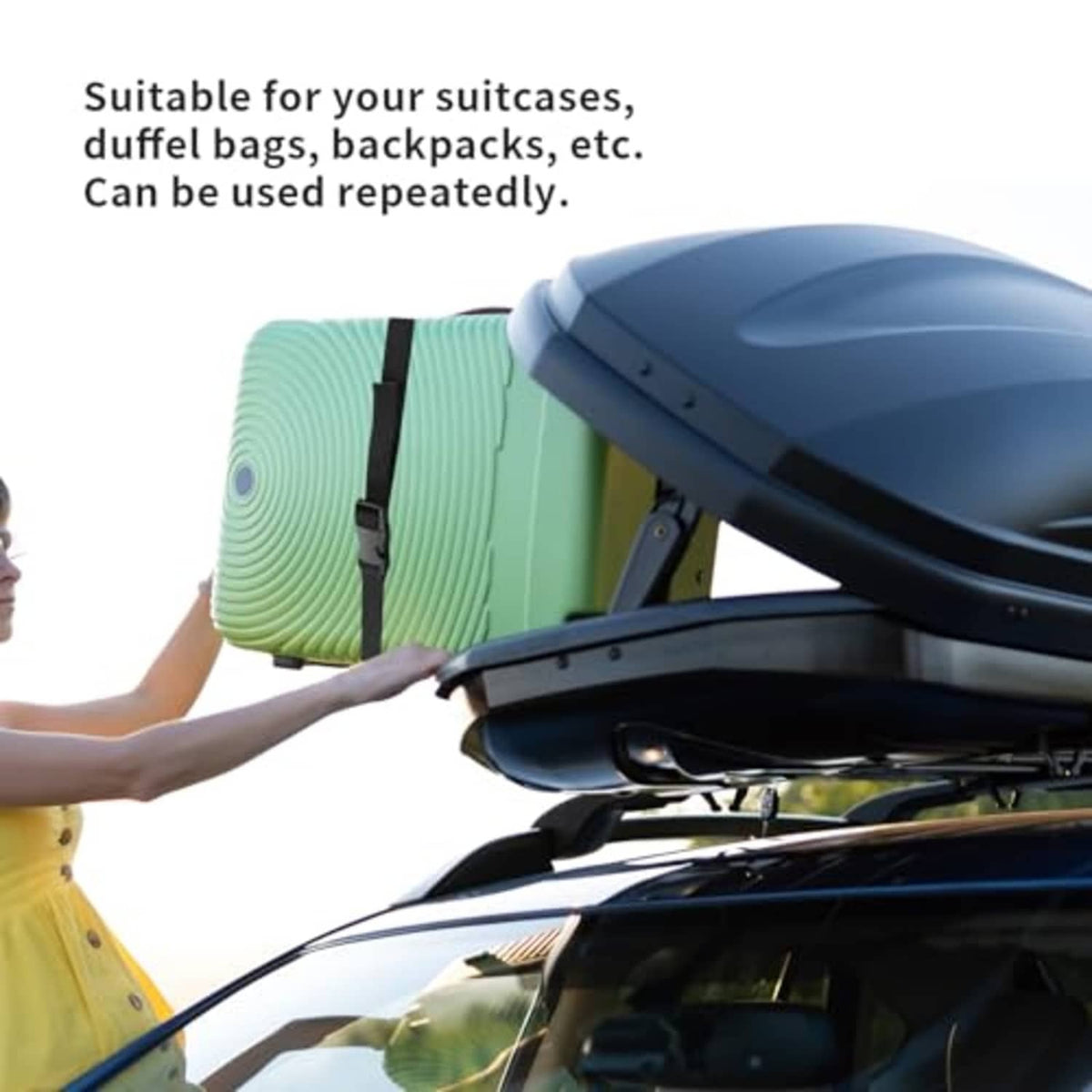 Black nylon tie-down strap securing luggage on a cart, for travel storage