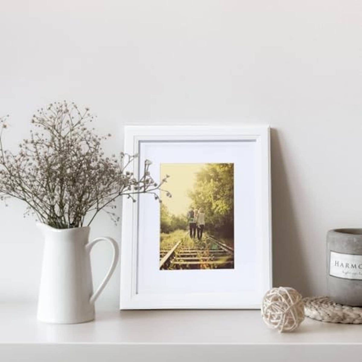 White wooden 8x10 picture frame on tabletop with landscape photo