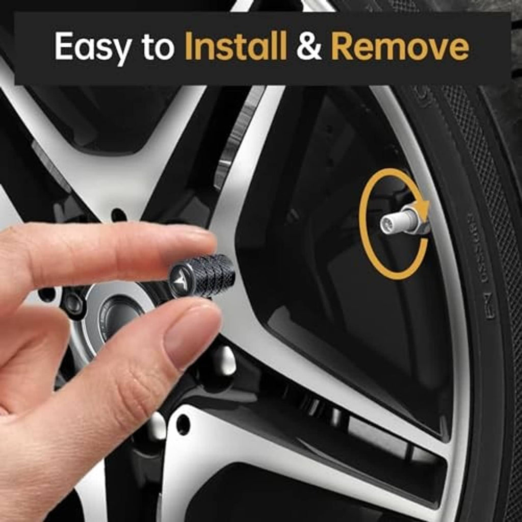 Black textured tire valve stem cap with V-emblem being installed on a car wheel