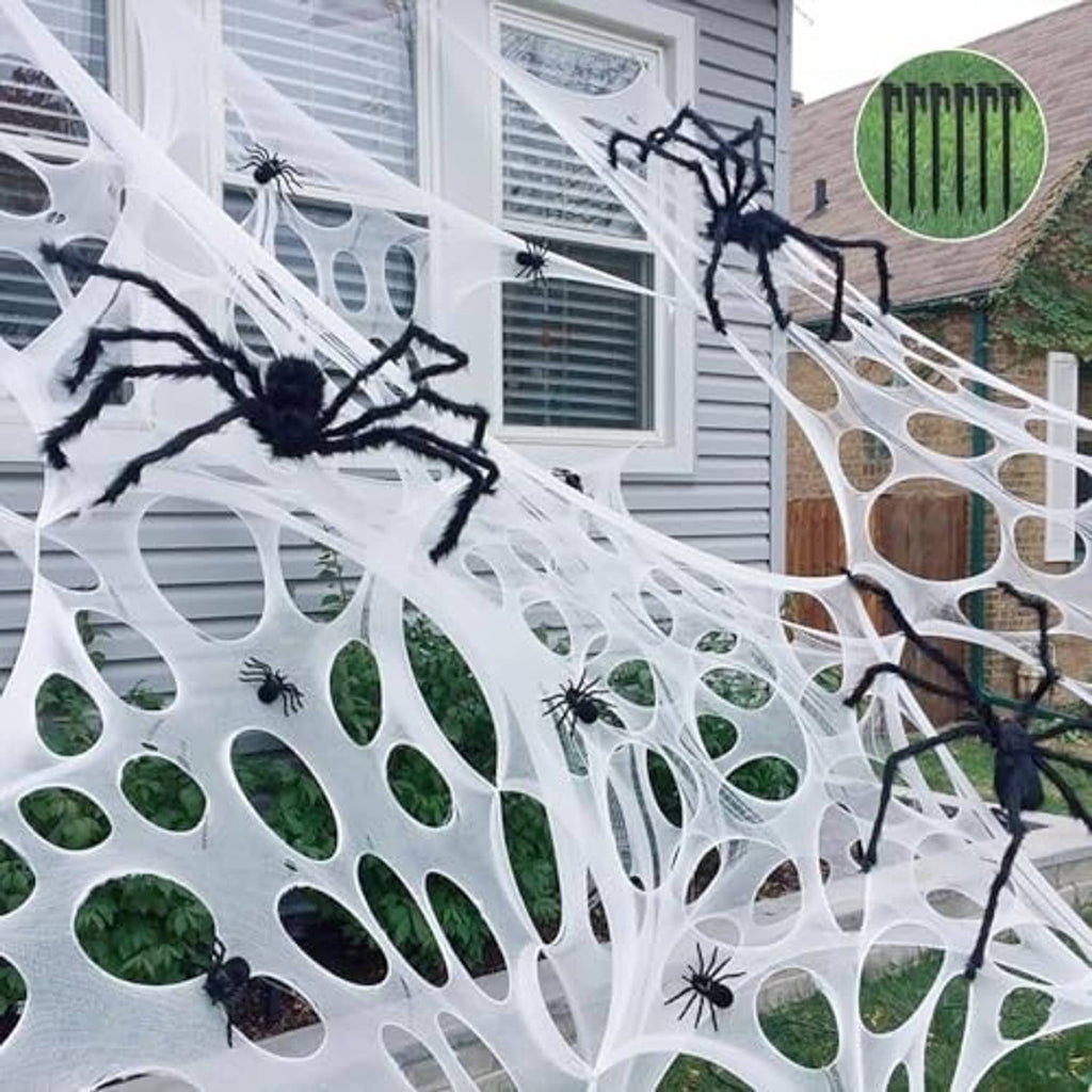 Outdoor Halloween spider web decoration with white webbing and several black spiders