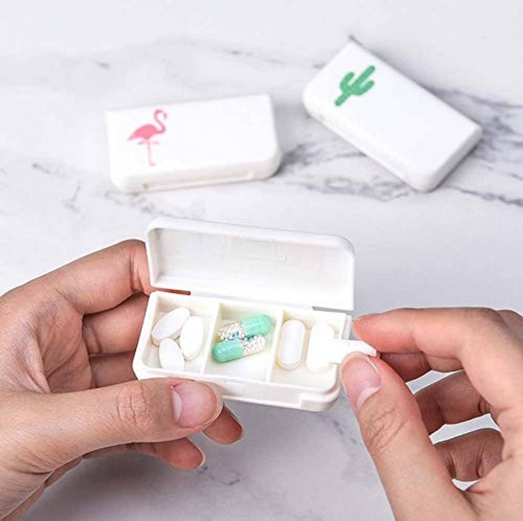 Small white pill organizer with hinged lid and divided slots holding tablets and capsules