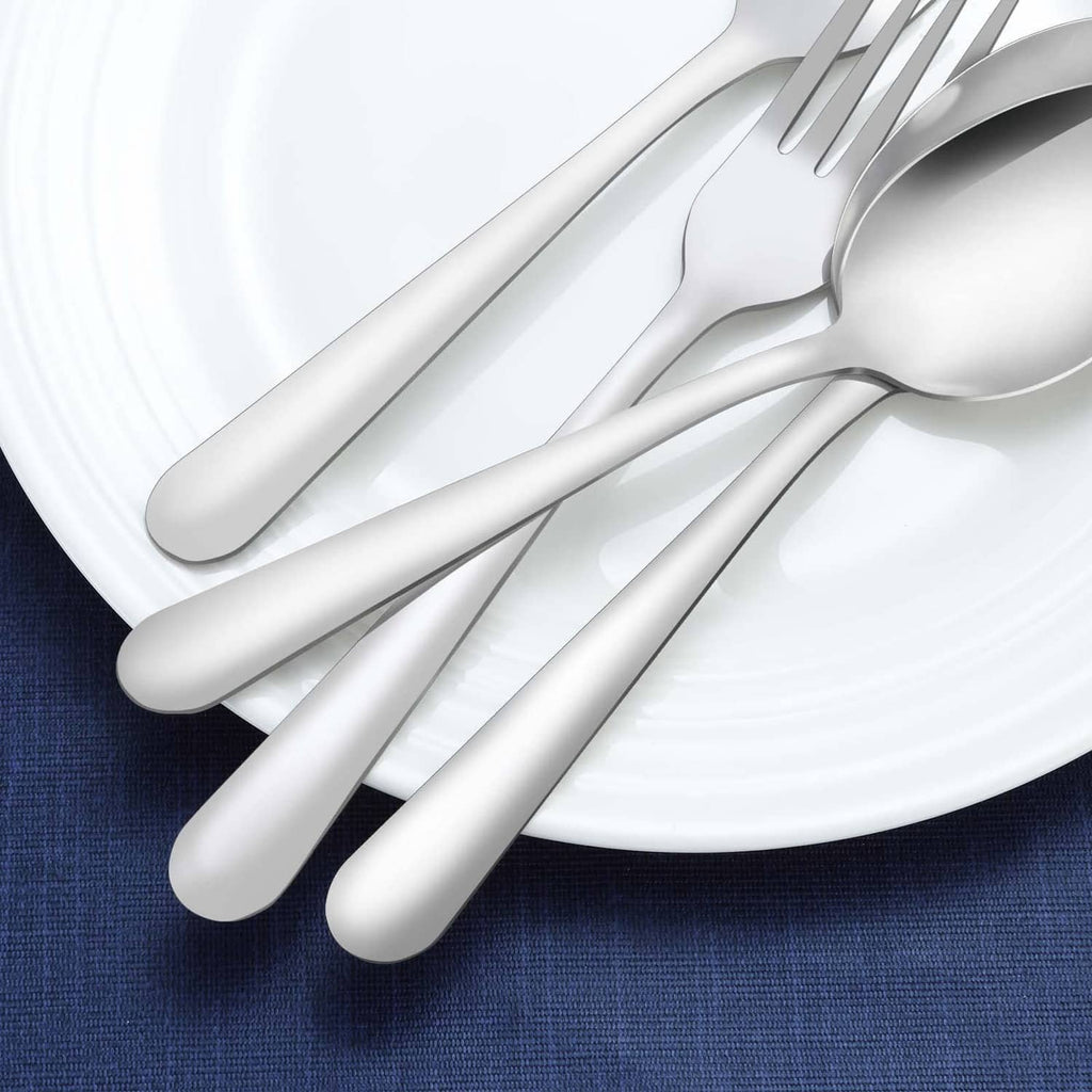 Funnydin stainless dinner spoons, polished silver, multiple spoons laid across a plate