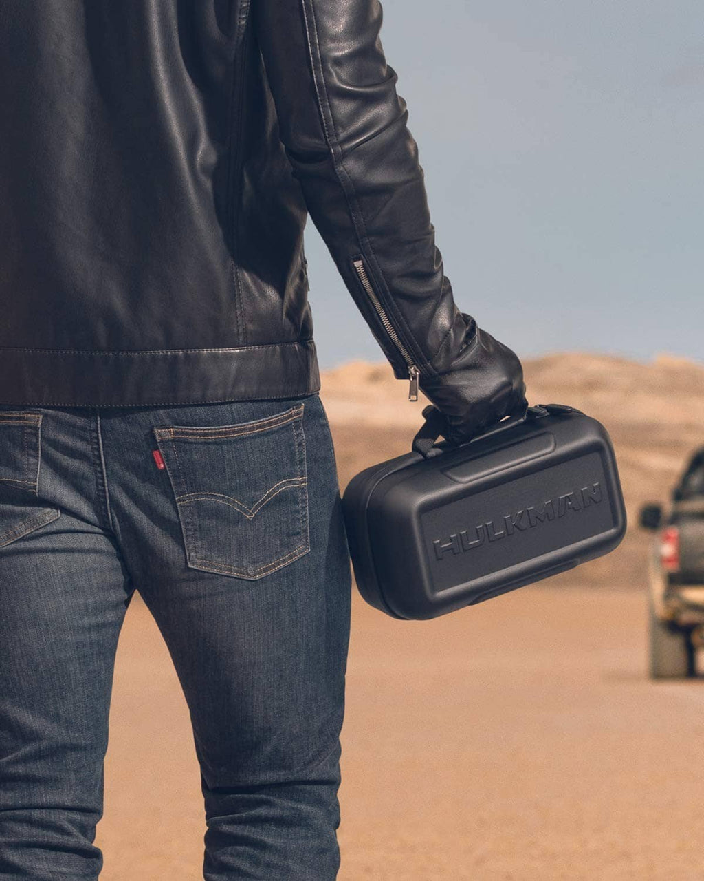 Black EVA protective case held in hand with HULKMAN logo on front.