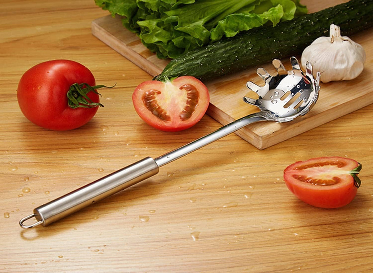 Stainless steel spaghetti server resting on wooden board with spoked disk head