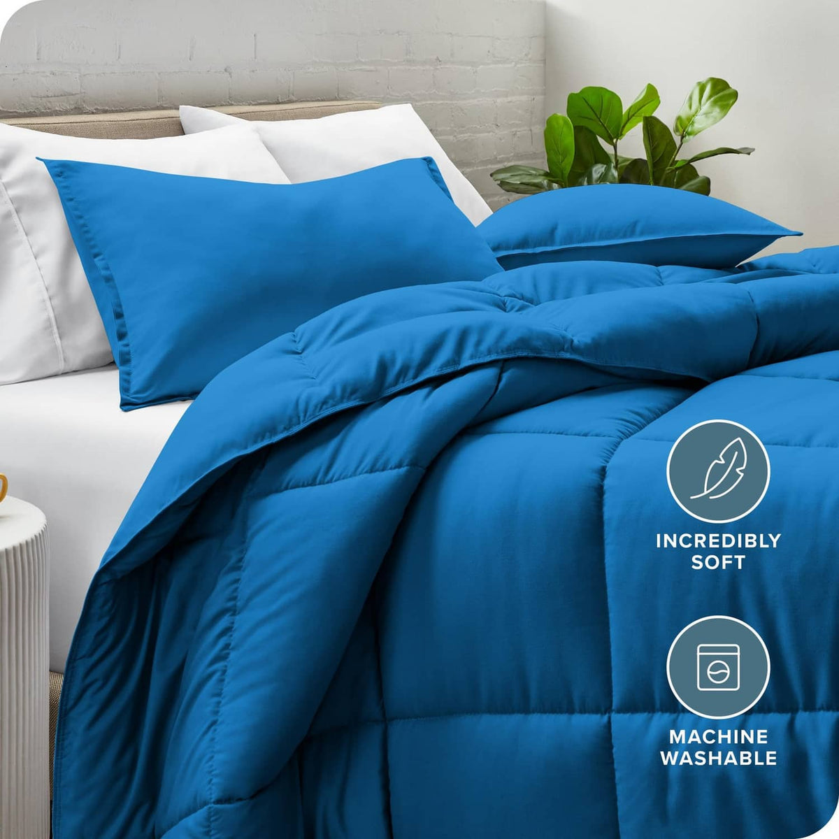 Blue comforter with matching pillow shams on bed, angled view