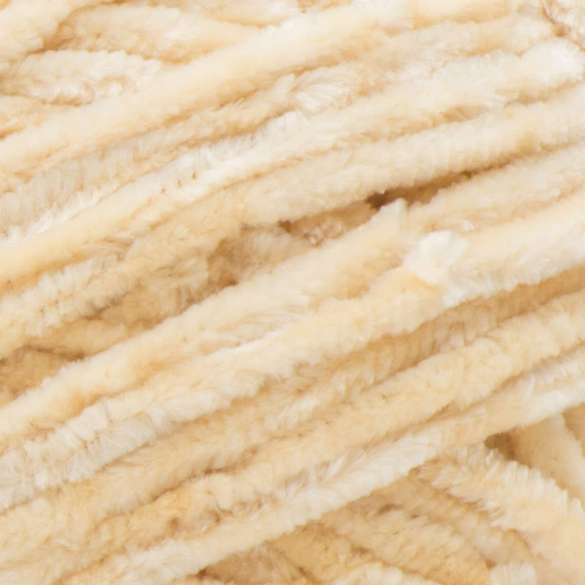 Bulky chenille yarn close-up in light cream with thick fuzzy loops