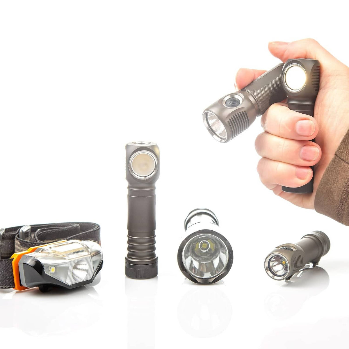 Convex clear lens front on metal flashlight-style tool with spare lenses