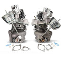 Left and right turbocharger pair with cast metal housings and outlet pipes