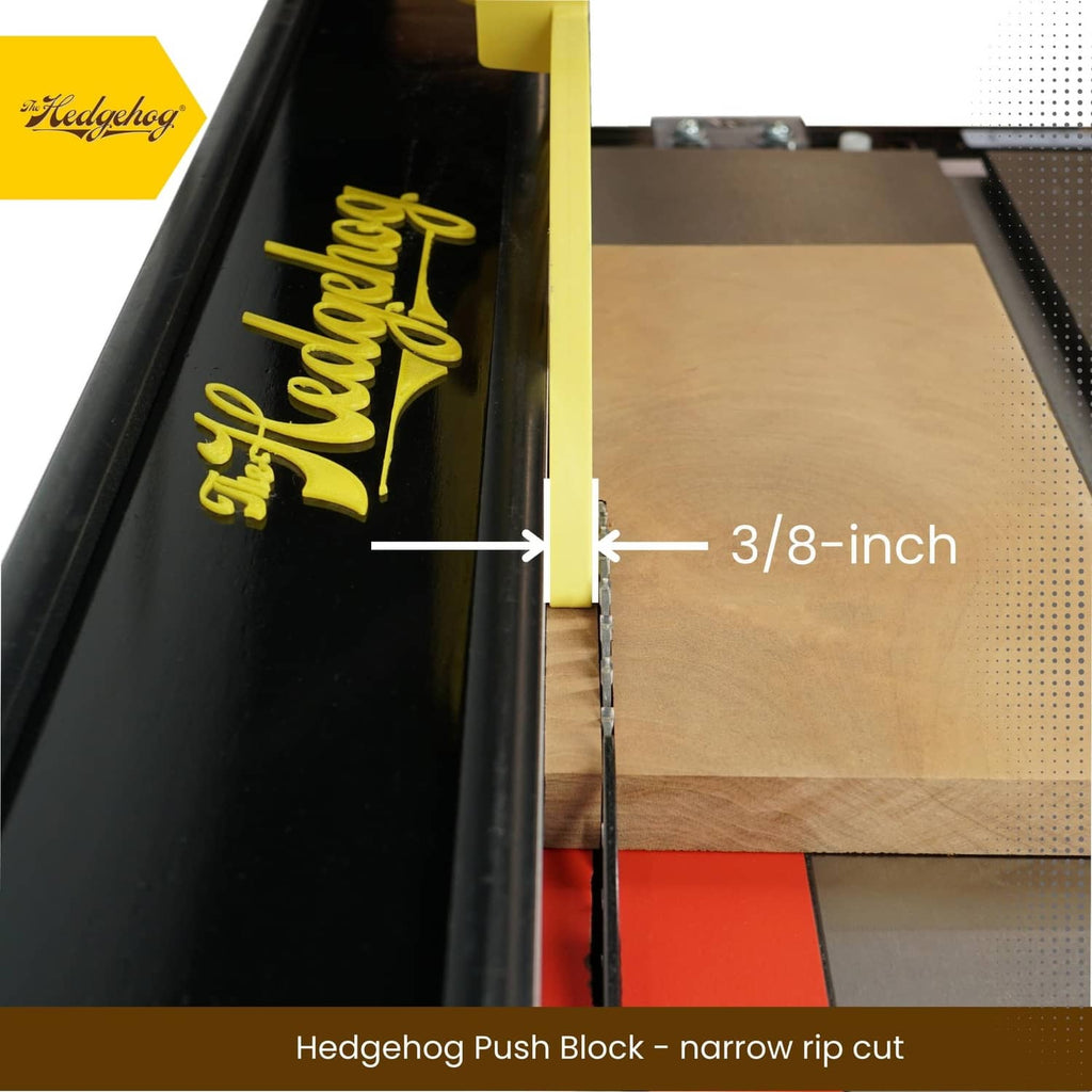 Yellow push block guiding a narrow wood board along a table saw fence