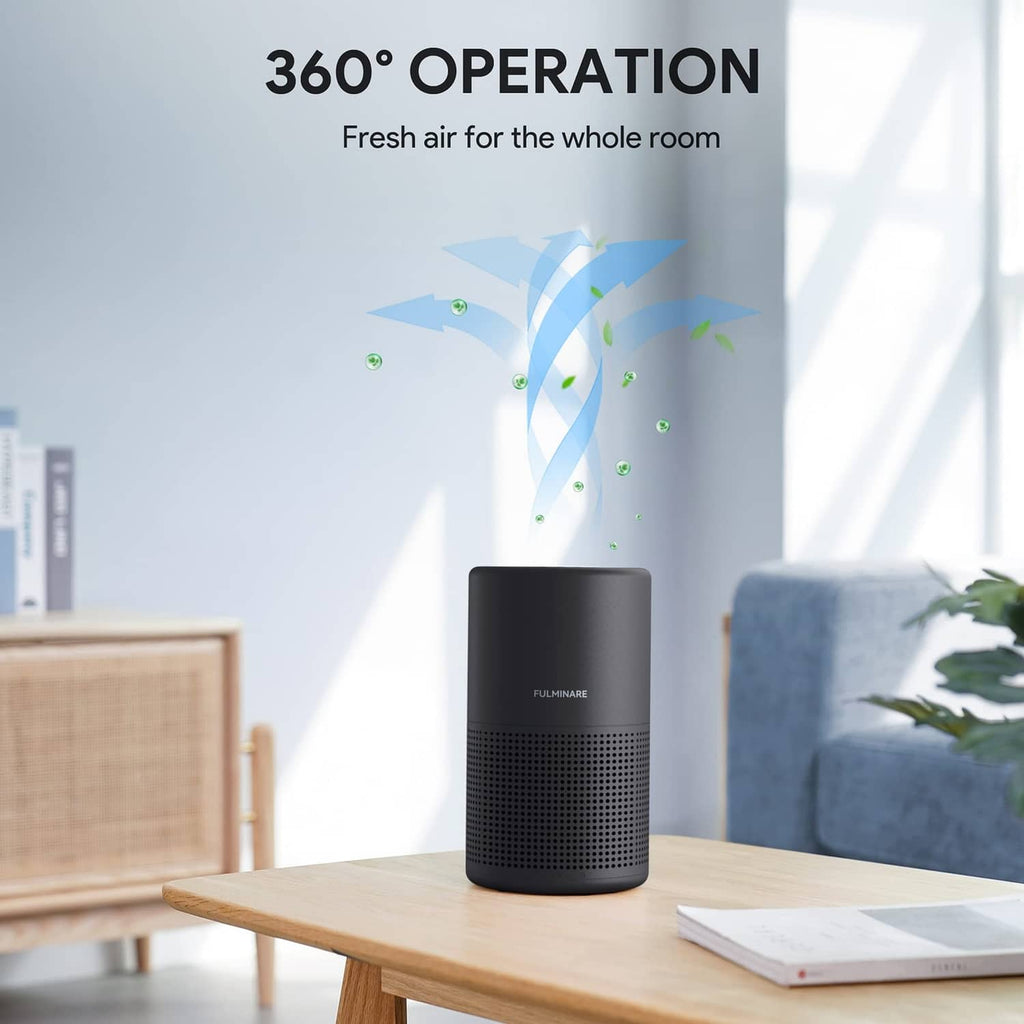 Black FULMINARE air purifier on wooden table with outward airflow
