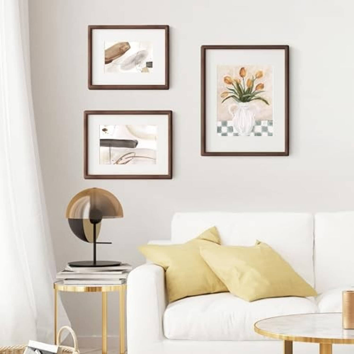 Walnut picture frame set with glass on a wall above a sofa