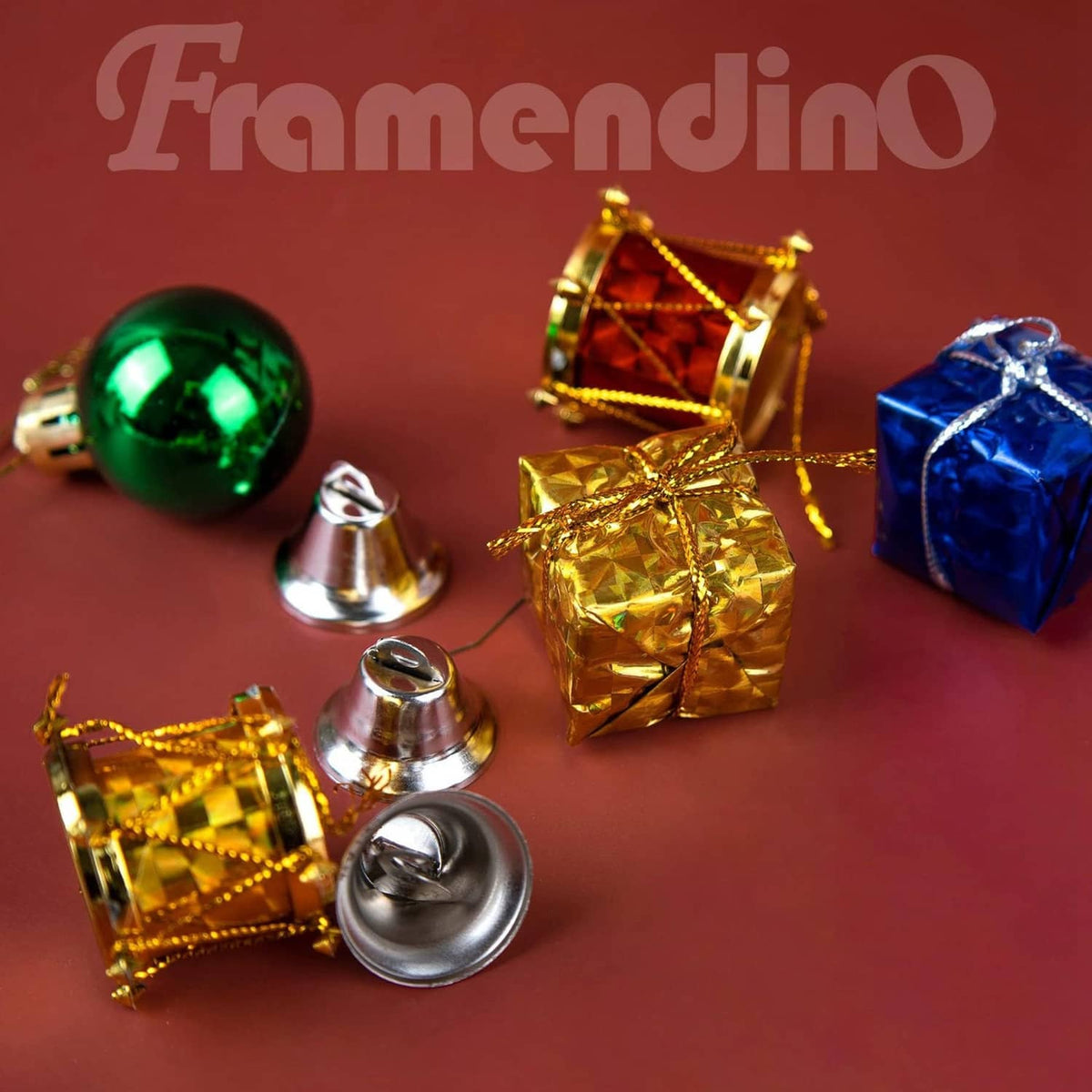 Silver mini jingle bells with loop hooks near gold and green ornaments
