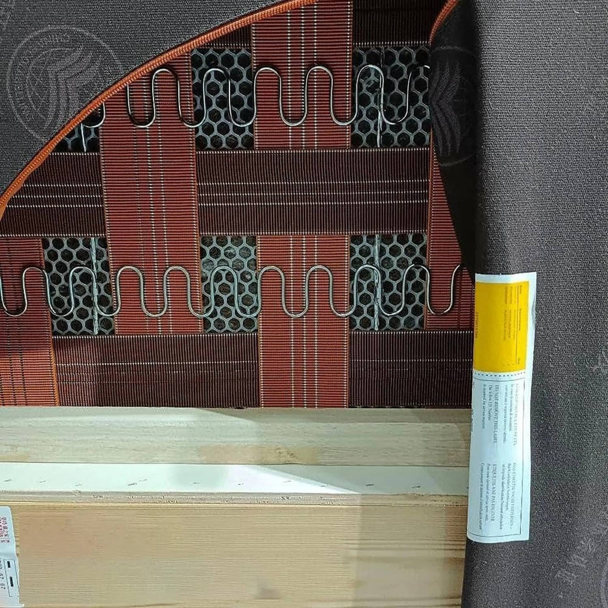 Upholstery spring support clips attached along a coiled spring grid