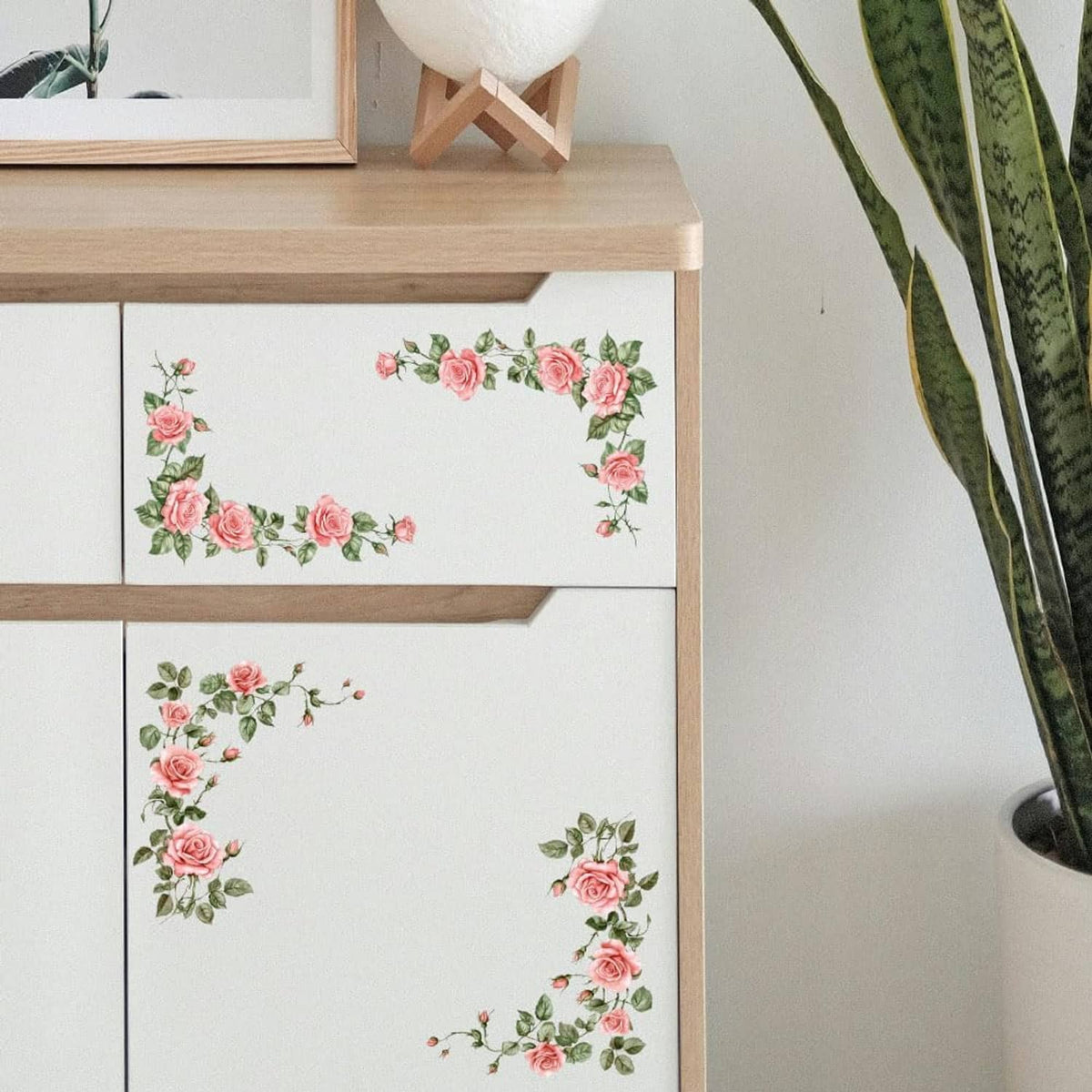 Pink rose vine transfer stickers applied to white cabinet drawers