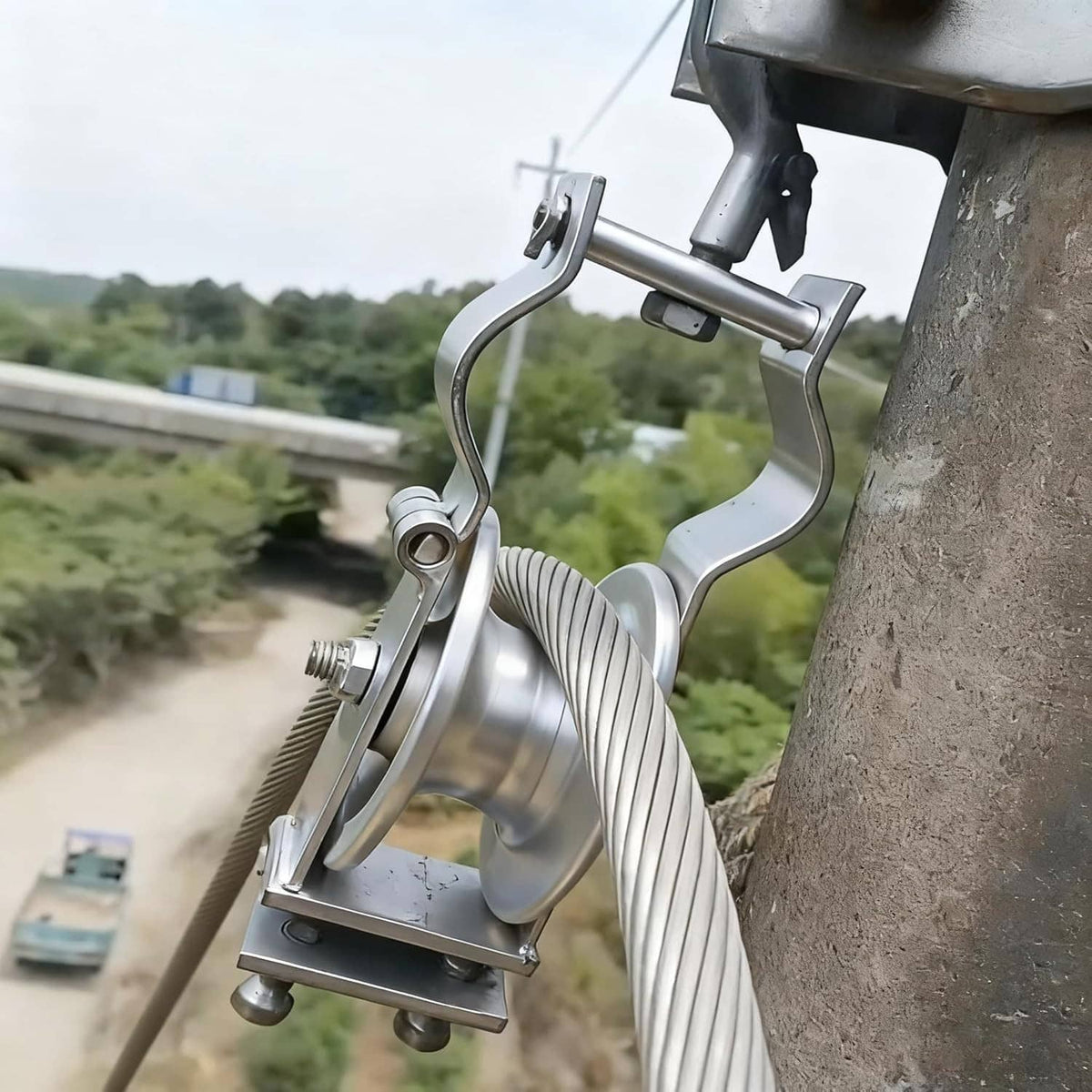 Galvanized cable pulley with hook assembly and ribbed cable line on outdoor mount