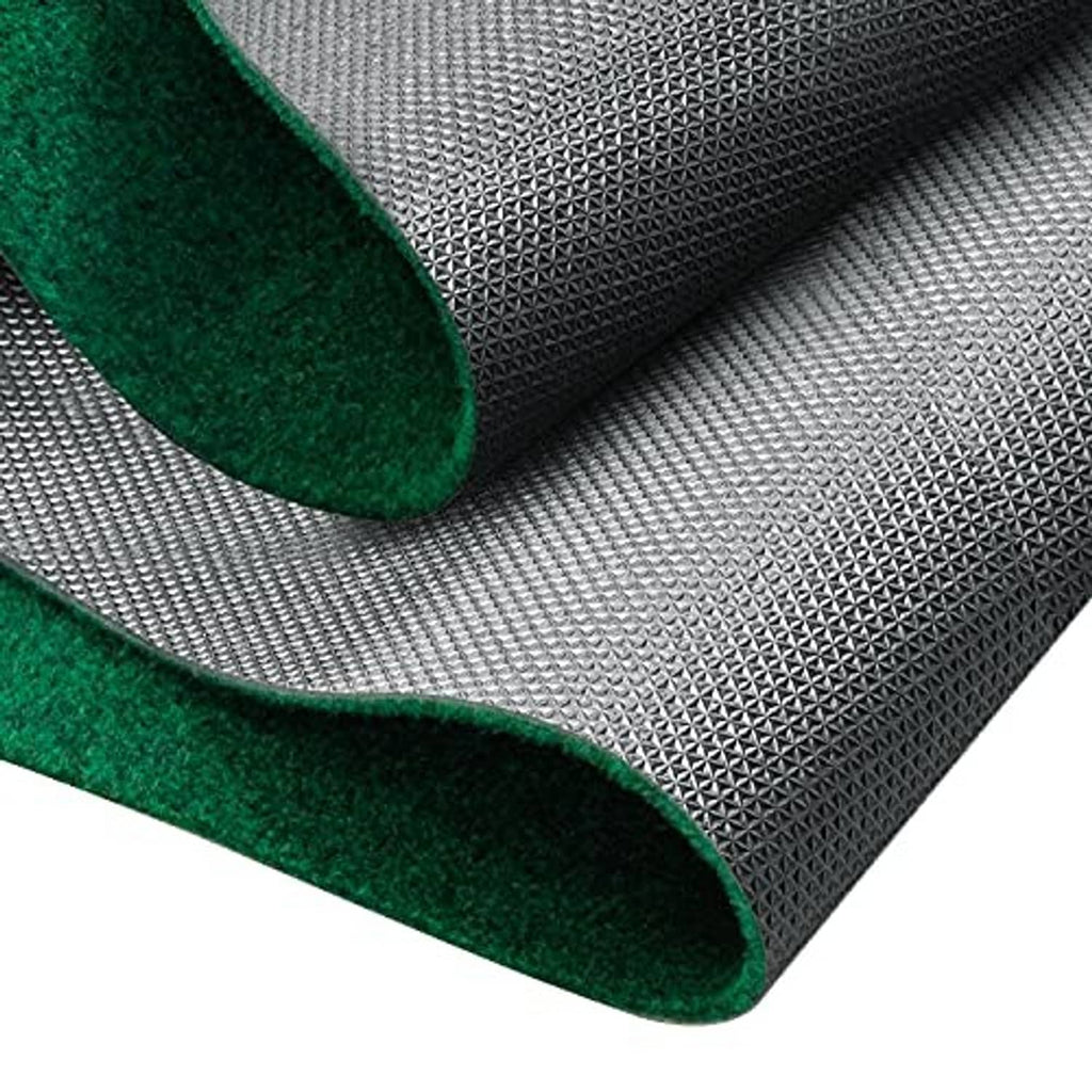 Close-up of rolled green putting mat edge on textured gray backing for cushioning