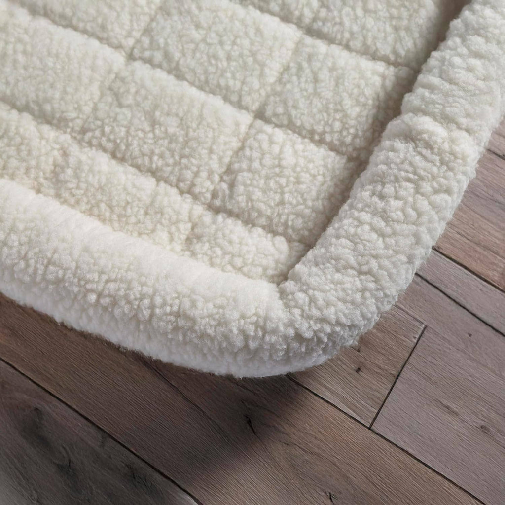 White fleece dog crate cover with thick, soft plush texture