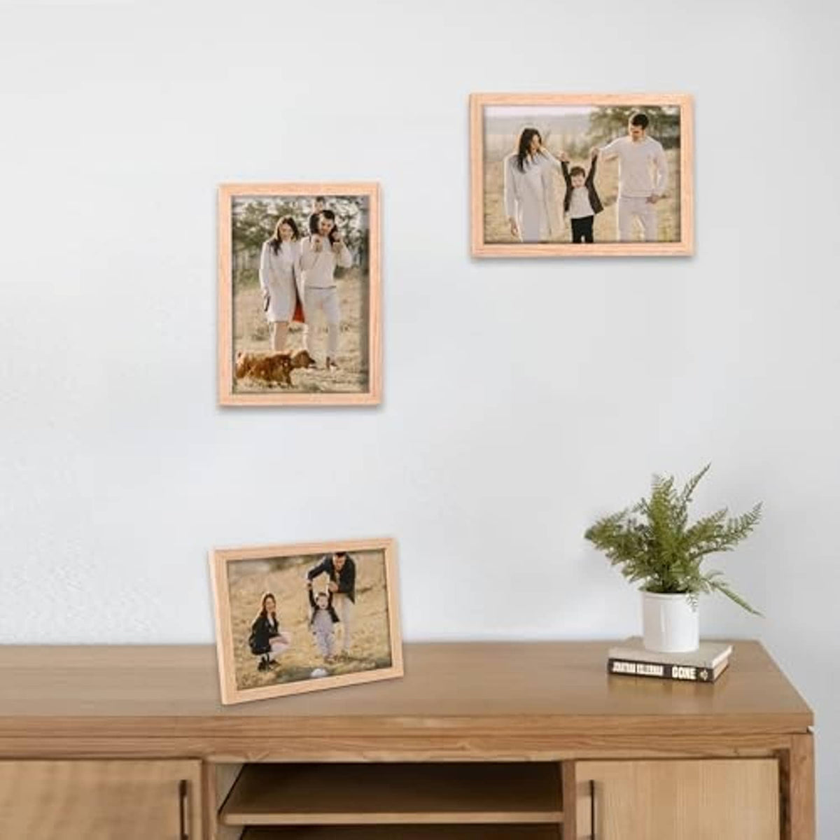Natural oak 8x10 photo frames on wall above console, three visible frames