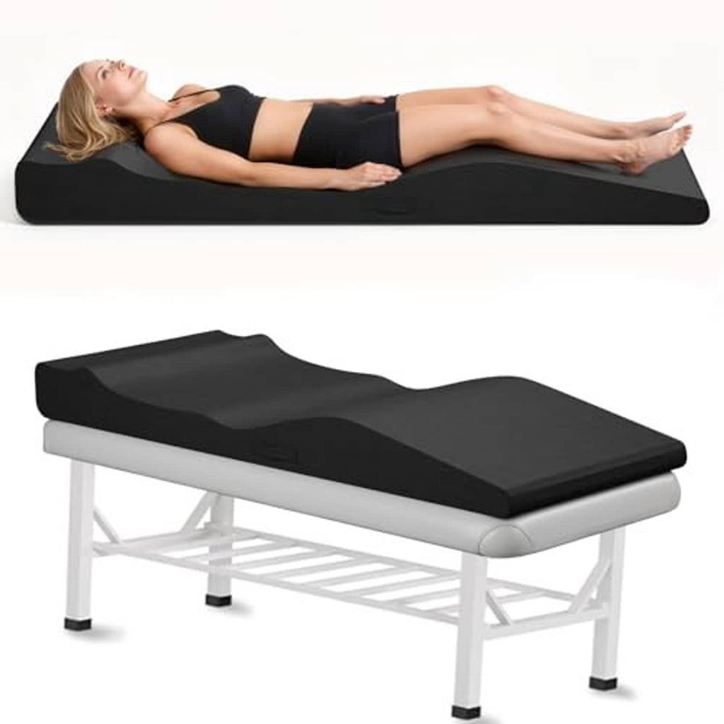 Black curved foam lash bed topper on white massage table frame