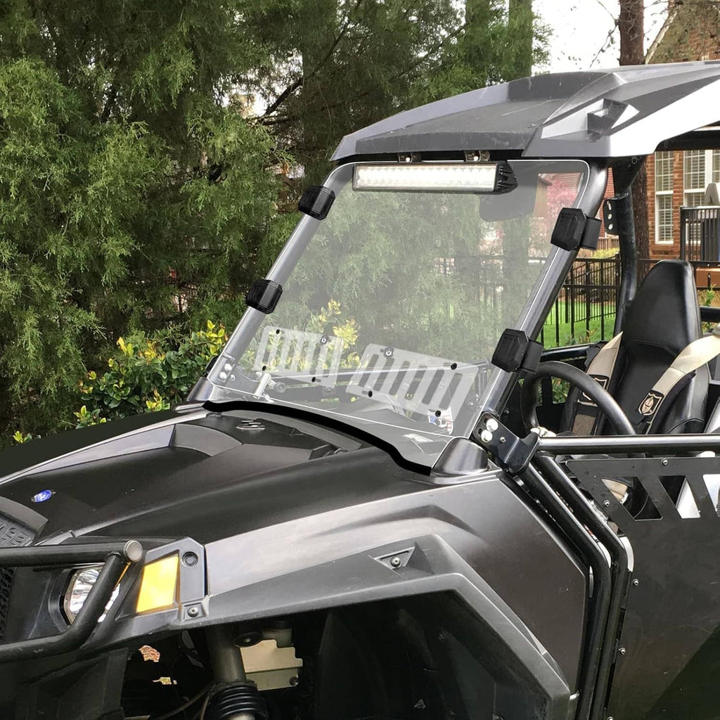 Clear vented windshield mounted on an off-road UTV with black brackets