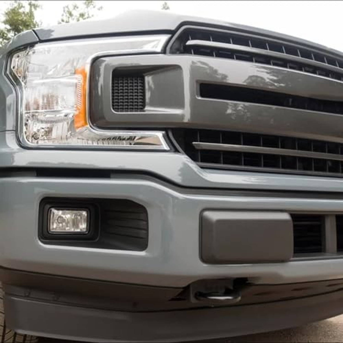 Front bumper guard insert installed on light gray truck bumper grille