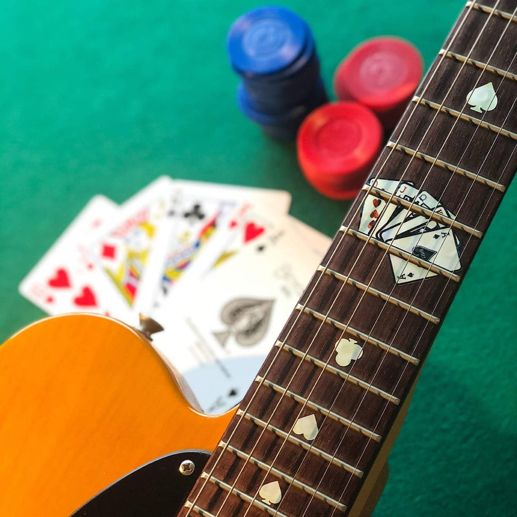 Guitar neck with white clover inlay stickers and playing-card decal rows