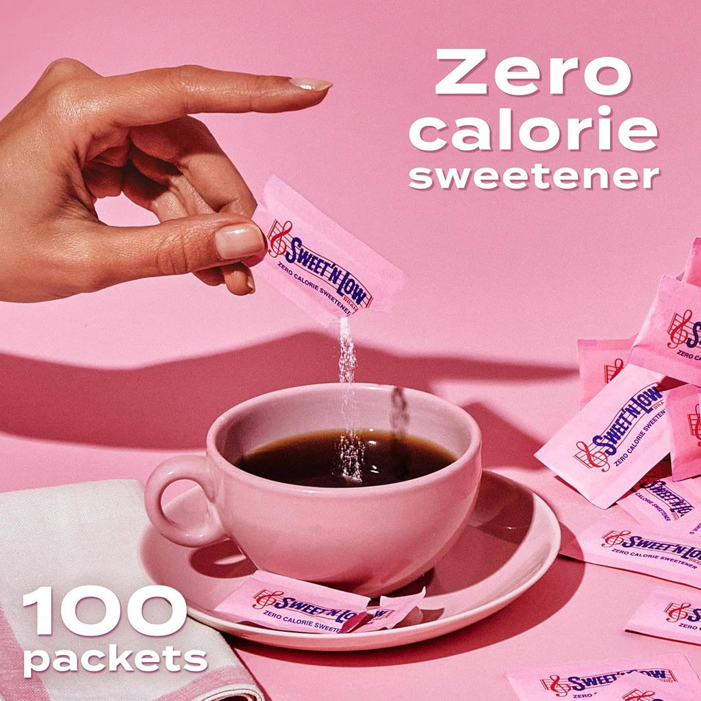 Hand pouring Sweet 'n Low zero-calorie sweetener packet into a cup of dark coffee